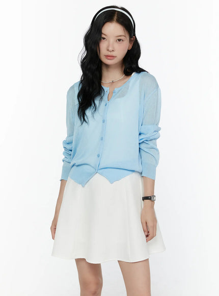 LEWKIN Sheer Knit Cropped Cardigan CL520 Light blue front shot on model wearing white mini skirt and pearl necklace, sheer lightweight knit