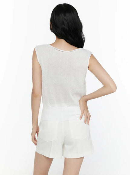 Sheer Knit Sleeveless Top CL521 White back shot on model hand on hip revealing sheer knit back panel ribbed hem and back neckline seam detail