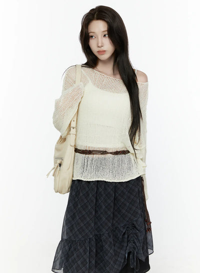 LEWKIN Sheer Knit Top IL522 Light beige three-quarter crop shot on model wearing open-shoulder style with cami underneath layered over dark plaid skirt with backpack