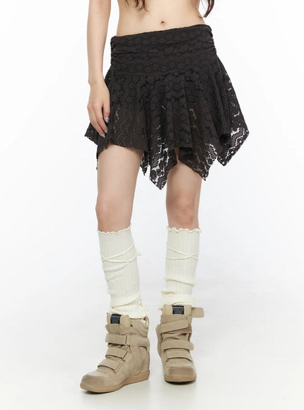 Sheer Lace Asymmetric Mini Skirt CL523 Dark brown front shot on model showing floral lace asymmetric mini skirt with semi-sheer texture and cream leg warmers