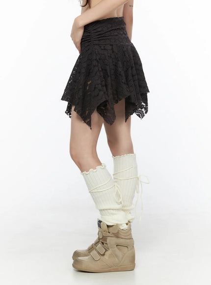 Sheer Lace Asymmetric Mini Skirt CL523 Dark brown side shot on model showing layered asymmetric lace hem and ruched waistband detail with cream leg warmers