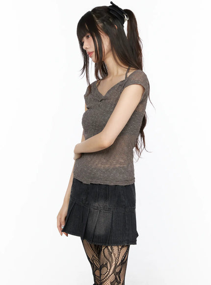 Sheer Lace Halter Off-Shoulder Tee CL522 Dark beige side view on model arms crossed showing off-shoulder cap sleeve sheer lace fabric with spaghetti strap accent
