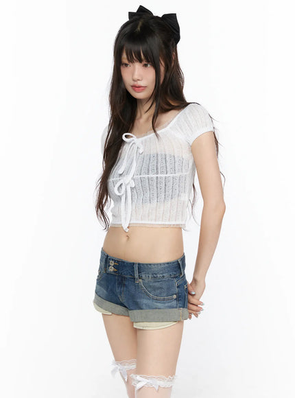 Sheer Lace Puff Sleeve Blouse CL523 White side-angle model shot with lace-up front tie detail, sheer openwork knit crop top styled with denim shorts