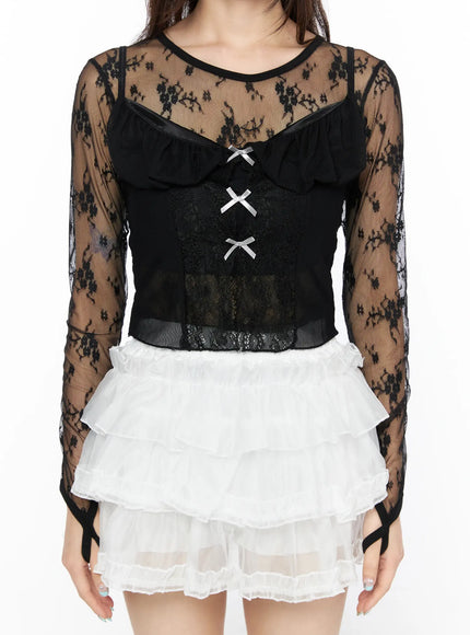 Sheer Lace Ribbon Tank CL522 Black close-up front detail shot showing sheer floral lace fabric, ruffled bib neckline, and silver ribbon bow closures