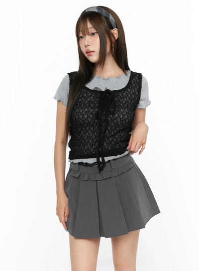 LEWKIN Sheer Lace Ribbon Tank Top CL514 Black S/M front view on model angled pose layered over gray lettuce-hem tee with gray pleated mini skirt floral lace texture ribbon tie