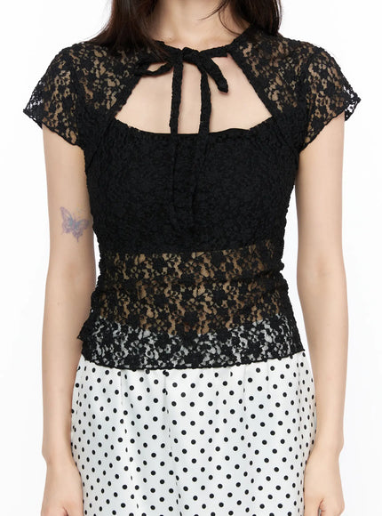 Sheer Lace Slit Tee CL522 Black close-up front model torso detail shot floral lace texture tie-neck cutout sheer layered hem with polka dot skirt