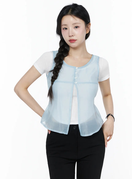 Sheer Layered Blouse IU525 Light blue close-up back detail shot on model, sheer fabric with knotted waist drawstring tie and rounded hem clearly visible