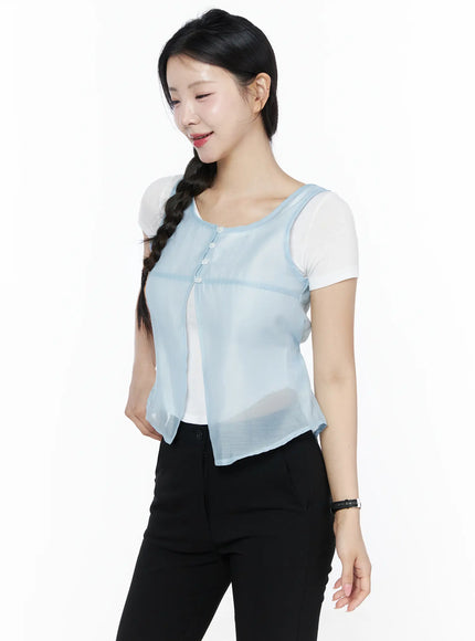 Sheer Layered Blouse IU525 Light blue front close-up torso shot, sheer chiffon vest open showing four-button placket, round neckline trim, and see-through texture