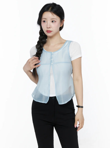 Sheer Layered Blouse IU525 Light blue three-quarter front model shot, model glancing sideways with hand through braid, sheer vest open front over white tee