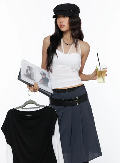 LEWKIN Sheer Layered Halter Top CL513 White S/M front model crop shot styled with navy pleated skirt and black belt, holding magazine and iced drink
