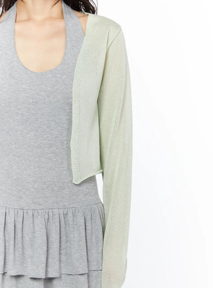 Sheer Lightweight Knit Cardigan CU530 Light green close-up detail shot on model showing sheer knit texture open-front lapel and sleeve over gray ribbed tank dress