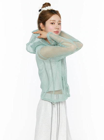 Sheer Mesh Hoodie CL501 Mint close-up side model shot arms crossed showing sheer open-knit mint mesh texture hood and long sleeves