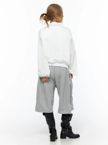 Sheer Nylon Windbreaker CU523 White back shot on model showing clean back panel semi-sheer nylon fabric elastic hem with gray striped wide-leg pants