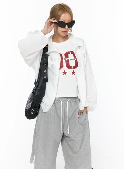 Sheer Nylon Windbreaker CU523 White S/M front shot on model wearing open over graphic tee styled with gray drawstring shorts and black bag