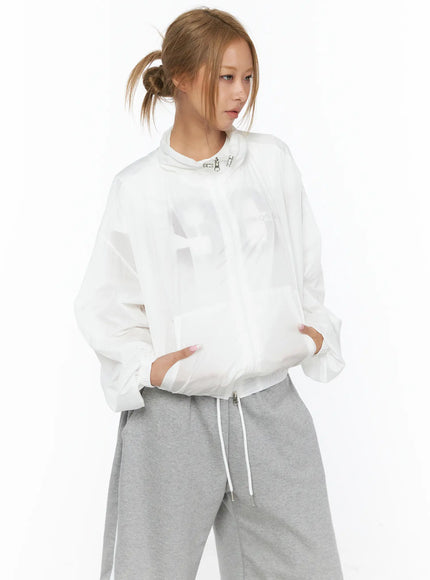 Sheer Nylon Windbreaker CU523 White front three-quarter shot on model hands in pockets showing tonal graphic print semi-sheer nylon bomber silhouette