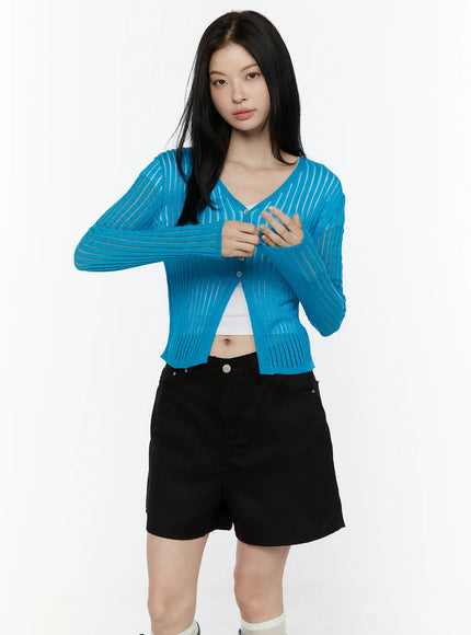 Sheer Ribbed Cardigan IL506 Blue front close-up shot on model with hands raised to chest highlighting semi-sheer ribbed knit texture and button front detail