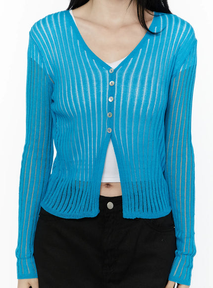 Sheer Ribbed Cardigan IL506 Blue close-up front detail shot on model highlighting V-neckline silver buttons sheer ribbed stripe knit texture and ribbed hem band