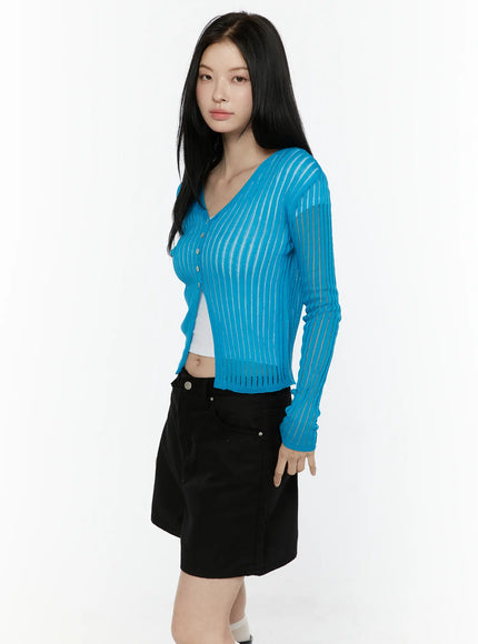 Sheer Ribbed Cardigan IL506 Blue side shot on model showing V-neckline button-down front sheer vertical stripe ribbed knit and cropped length layered over white top