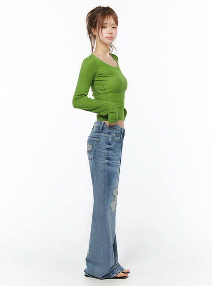 Sheer Slim Fit Long Sleeve Top IU525 Green side profile full body view on model showing slim ribbed crop top with waist-grazing hem paired with flared ripped jeans