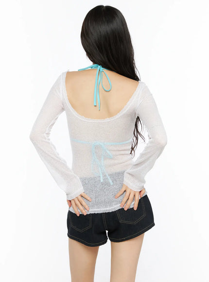 Sheer Slim U-Neck Top CU530 White back shot model showing open U-back neckline sheer knit long sleeves blue halter bralette tie visible through fabric over denim shorts