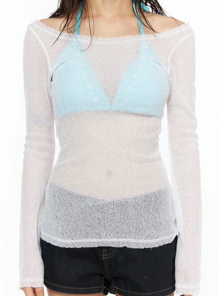 Sheer Slim U-Neck Top CU530 White cropped detail shot model torso showing off-shoulder neckline sheer knit weave long sleeves and frayed hem edge over blue bralette