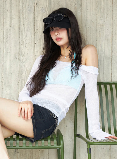 LEWKIN Sheer Slim U-Neck Top CU530 White size S/M outdoor lifestyle shot model seated on green chair off-shoulder sheer knit layered over blue bralette with denim shorts
