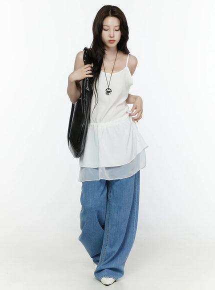 Sheer Strap Layered Dress IL521 White full-length front view on model looking down, carrying studded black tote, with pendant necklace, peplum silhouette, wide-leg jeans