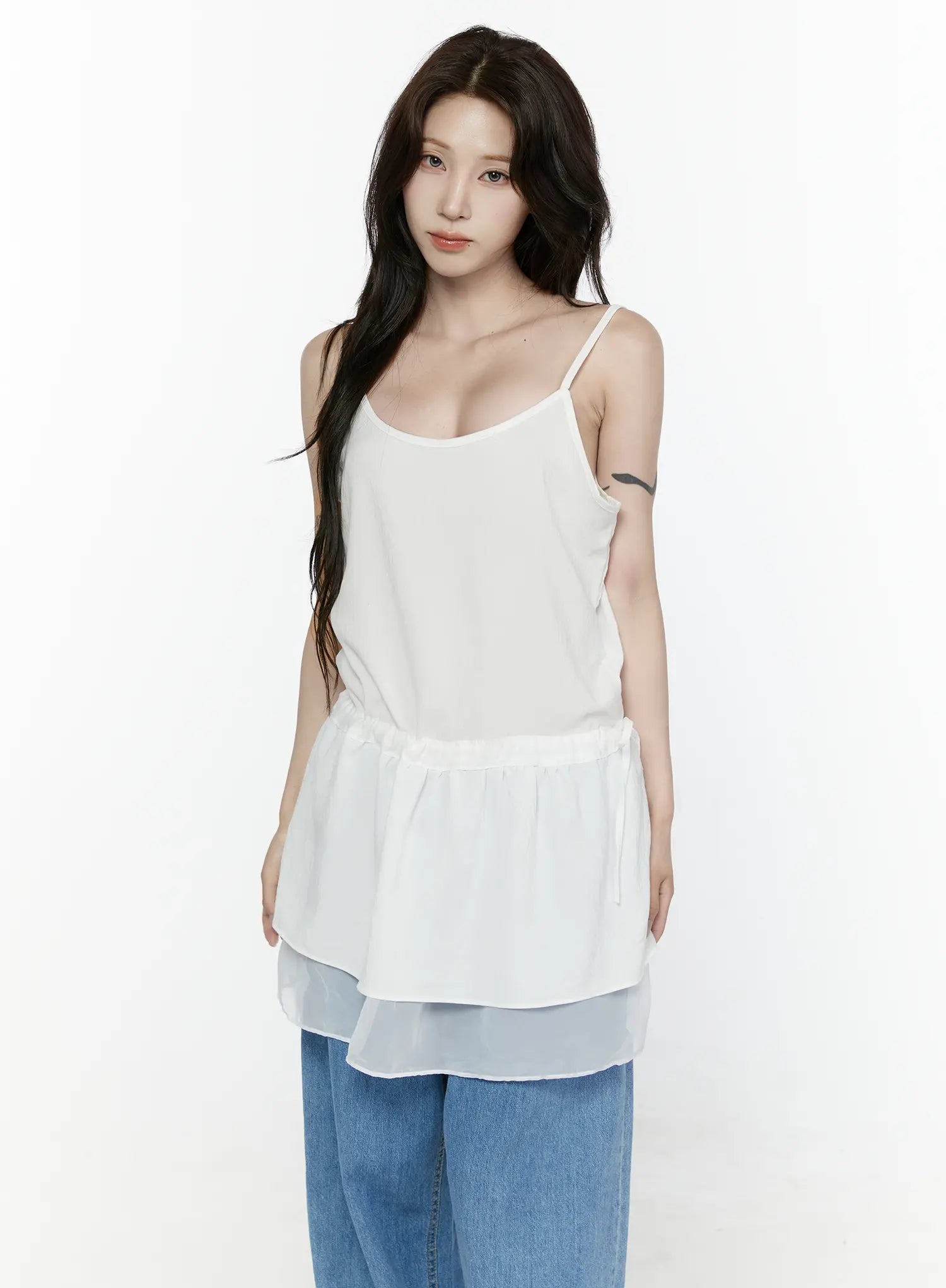 Sheer Strap Layered Dress IL521 White half-body front view on model with direct gaze, showing spaghetti straps, scoop neck, peplum waist, sheer hem, styled with blue jeans