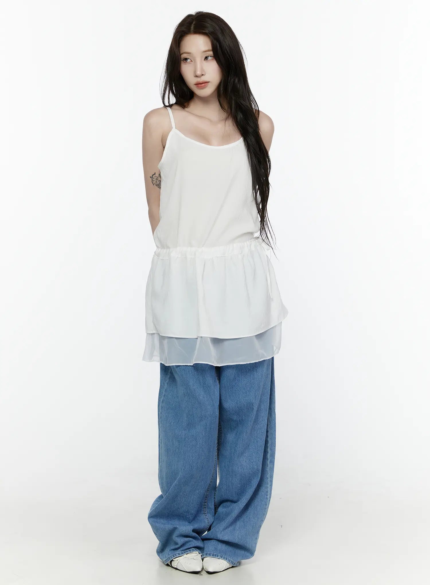 Sheer Strap Layered Dress IL521 White full-length front view on model standing straight, showing spaghetti straps, peplum ruffle, sheer organza hem, with wide-leg jeans and white shoes