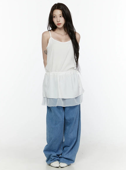 Sheer Strap Layered Dress IL521 White full-length front view on model standing straight, showing spaghetti straps, peplum ruffle, sheer organza hem, with wide-leg jeans and white shoes