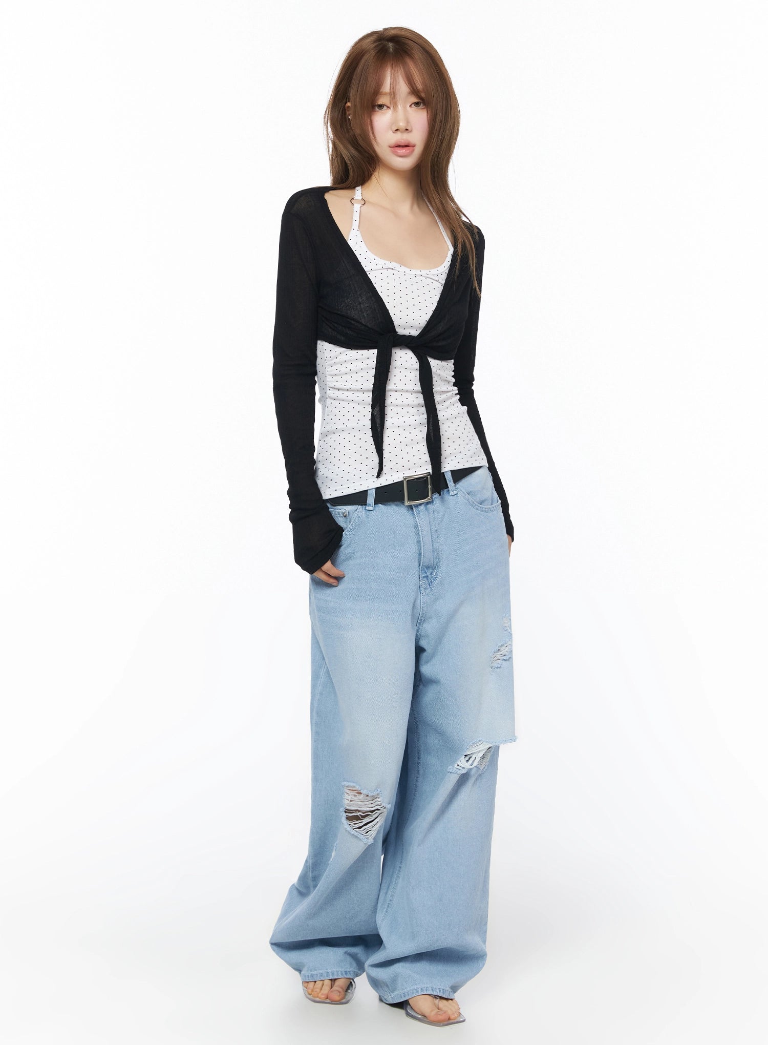 Sheer Tie-Front Wrap Crop Cardigan IL502 Black full-body front model shot standing sheer lightweight knit tie-front crop styled with polka dot inner and baggy denim