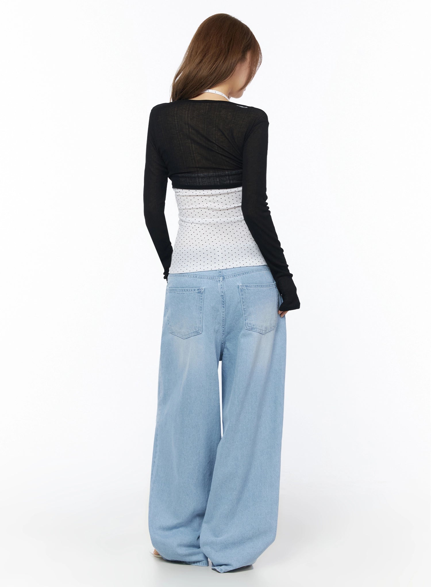 Sheer Tie-Front Wrap Crop Cardigan IL502 Black back model shot revealing semi-sheer knit fabric open back design layered over white polka dot top with wide-leg jeans