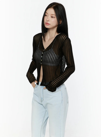 Sheer V-Neck Cardigan IL506 Black three-quarter front shot model hand in pocket wearing sheer stripe ribbed knit cardigan unbuttoned with light blue wide-leg jeans