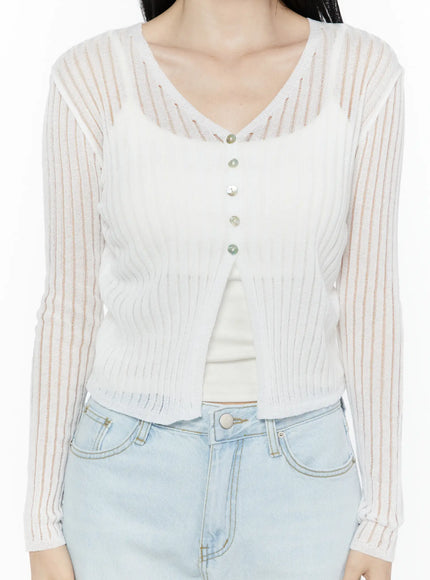 Sheer V-Neck Cardigan IL506 White close-up front detail shot showing V-neck pearlescent buttons sheer stripe ribbed knit fabric layered over white inner camisole