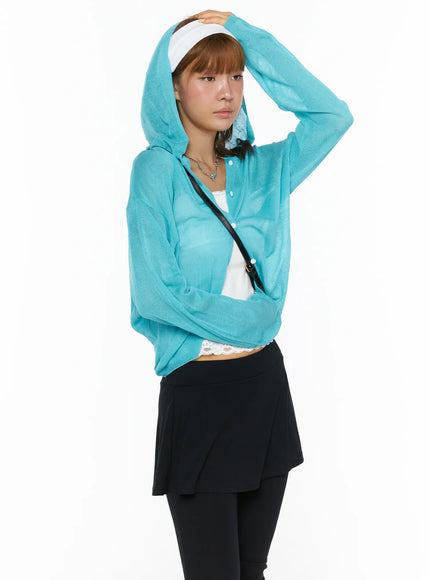 LEWKIN Sheered Hooded Cardigan CL503 Blue S/M side shot on model wearing hood up, hand raised to head, sheer knit texture visible, styled with white lace top and black skirt