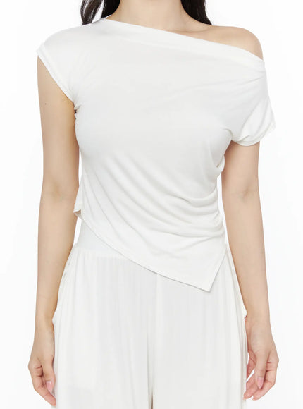 Shirred Boat Neck Tee and Sweatpants Set IU525 White detail close-up on model torso highlighting shirred waist, asymmetric pointed hem, and soft knit texture