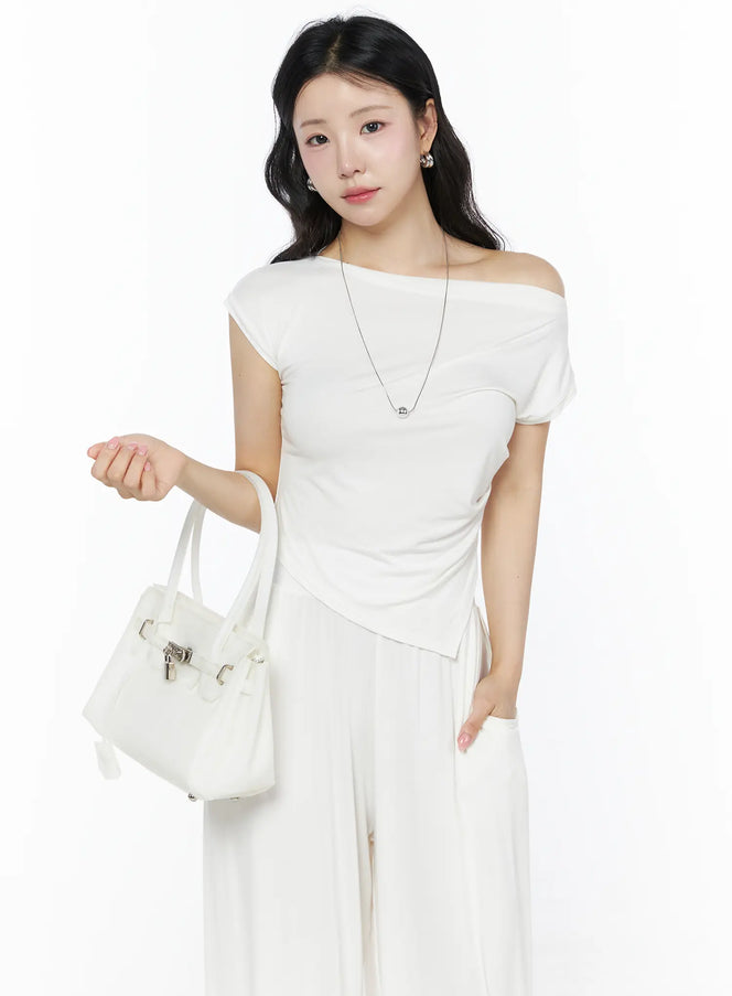 LEWKIN Shirred Boat Neck Tee and Sweatpants Set IU525 White S/M front shot on model holding white tote bag, asymmetric off-shoulder ruched top with cap sleeve