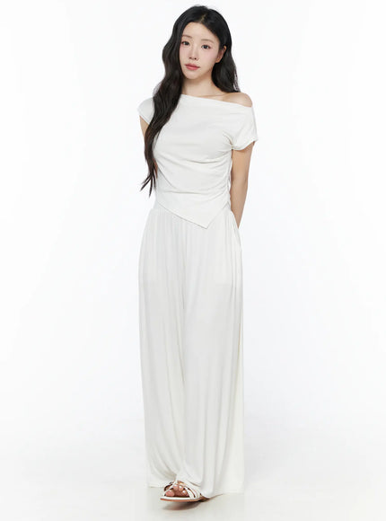Shirred Boat Neck Tee and Sweatpants Set IU525 White full-length front shot on model standing upright with hand in pocket, asymmetric hem top and wide-leg pants