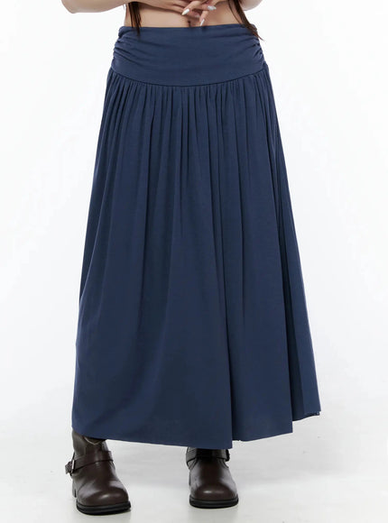 Shirred Flare Maxi Skirt IL502 Dark blue front waist-down shot on model with hands resting on waist, ruched foldover band and flowing gathered maxi hem visible