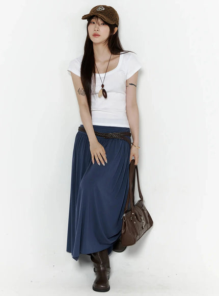 Shirred Flare Maxi Skirt IL502 Dark blue full-body front shot on model styled with white scoop-neck tee, leopard cap, braided belt, and brown bag