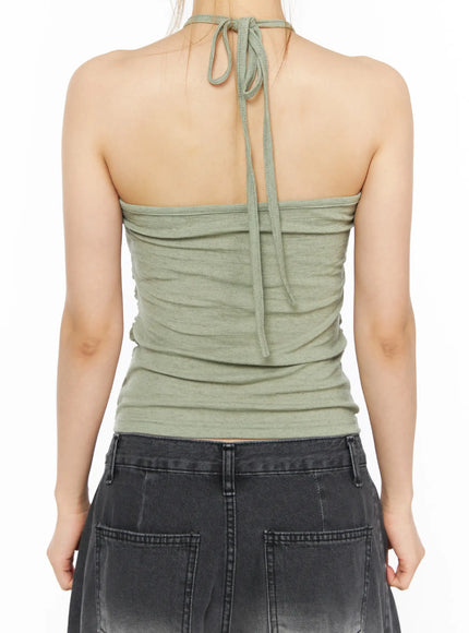 Shirred Halter Top CL501 Dark green close-up back torso shot on model showing open back with dangling halter tie cord and ruched fabric detail