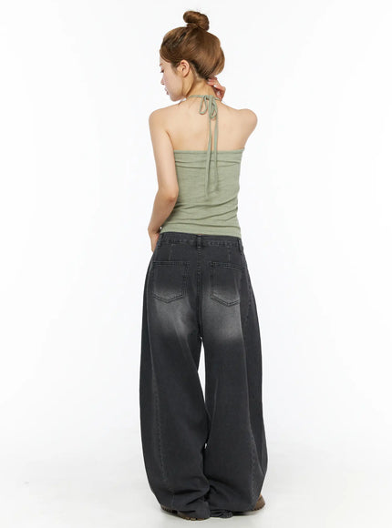 Shirred Halter Top CL501 Dark green back view on model showing halter tie at nape and open back, ruched fabric texture, styled with charcoal wide-leg jeans
