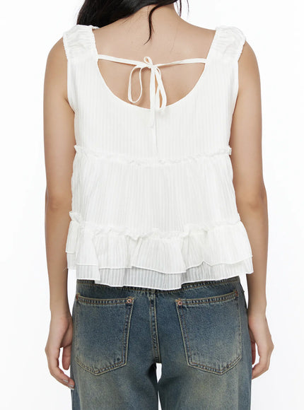 Shirred Ribbon Sleeveless Blouse CL510 White back shot on model showing open-back ribbon tie detail, ruffle straps and layered tiered hem in textured stripe fabric