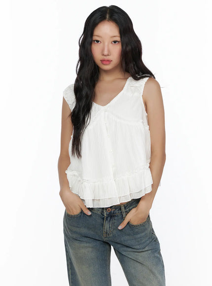 Shirred Ribbon Sleeveless Blouse CL510 White close-up front shot on model showing V-neckline, button placket, shirred shoulders and tiered ruffle hem