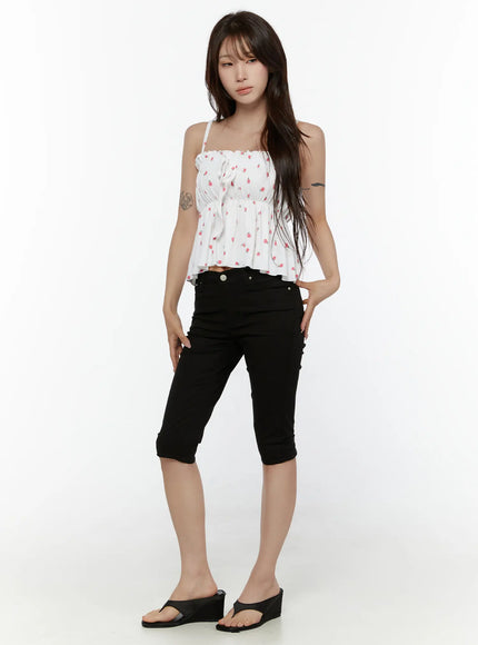 Shirred Ribbon Sleeveless Top CL507 White full-length front shot on model with hand on hip, styled with black capri pants and wedge sandals, flared ruffle hem visible