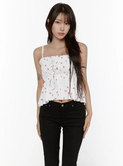 LEWKIN Shirred Ribbon Sleeveless Top CL507 White S/M front view on model wearing black skinny jeans, rose print smocked bodice with center ribbon tie and ruffle hem