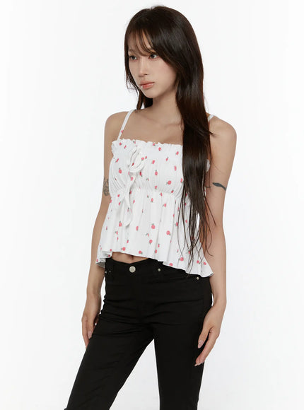 Shirred Ribbon Sleeveless Top CL507 White three-quarter side front view on model showing ribbon tie detail, shirred elastic waist and flowy peplum hem with rose print