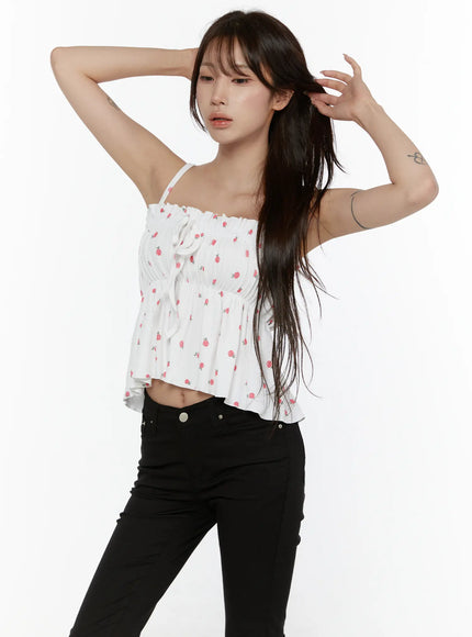 Shirred Ribbon Sleeveless Top CL507 White dynamic pose on model with arm raised showing side angle, spaghetti straps and shirred waist with floral rose print detail