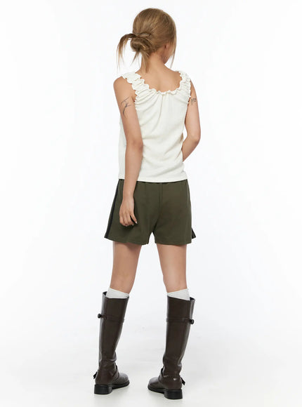 Shirred Ruffle Tank Top CU524 Light beige back view on model standing in olive shorts showing ruffle strap and textured fabric detail