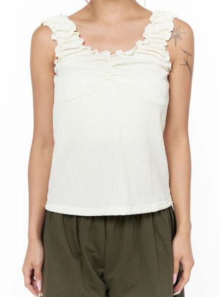 Shirred Ruffle Tank Top CU524 Light beige close-up front torso shot on model showing ruched center seam ruffled neckline and crinkle texture